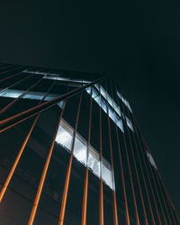 Low angle view of illuminated building against clear sky at night