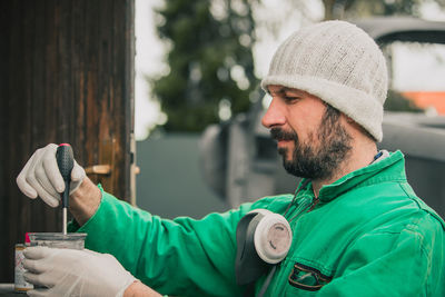 Portrait of man holding hat