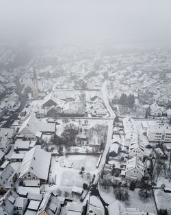 High angle view of townscape and trees during winter