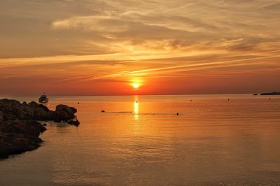 Scenic view of sea against orange sky