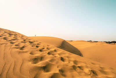 Scenic view of desert against clear sky