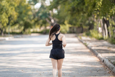 Rear view of woman standing outdoors