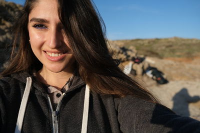 Close-up portrait of a smiling young woman