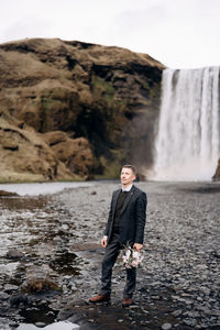 Portrait of man standing on rock