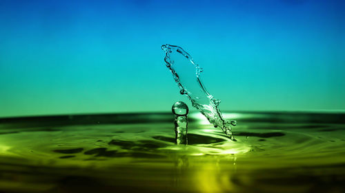 Close-up of water splashing against blue background