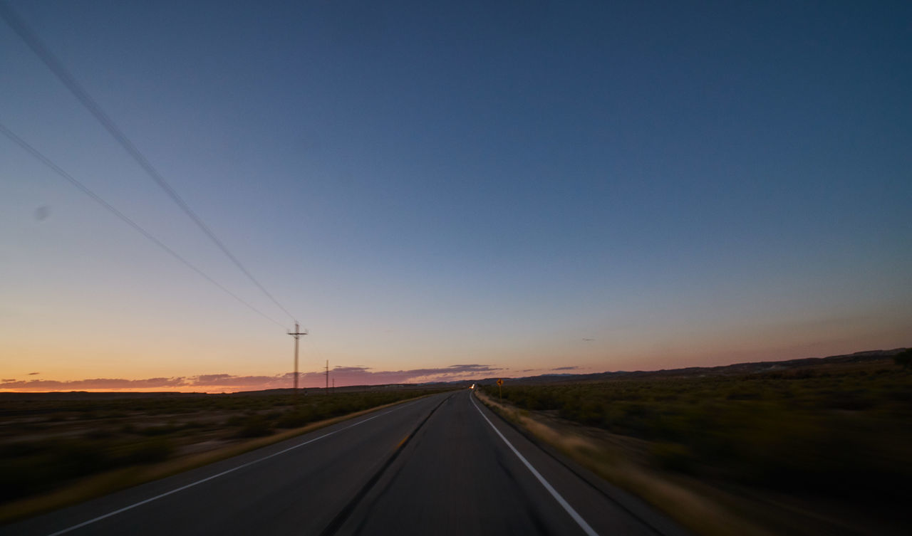 ROAD AGAINST CLEAR SKY AT SUNSET