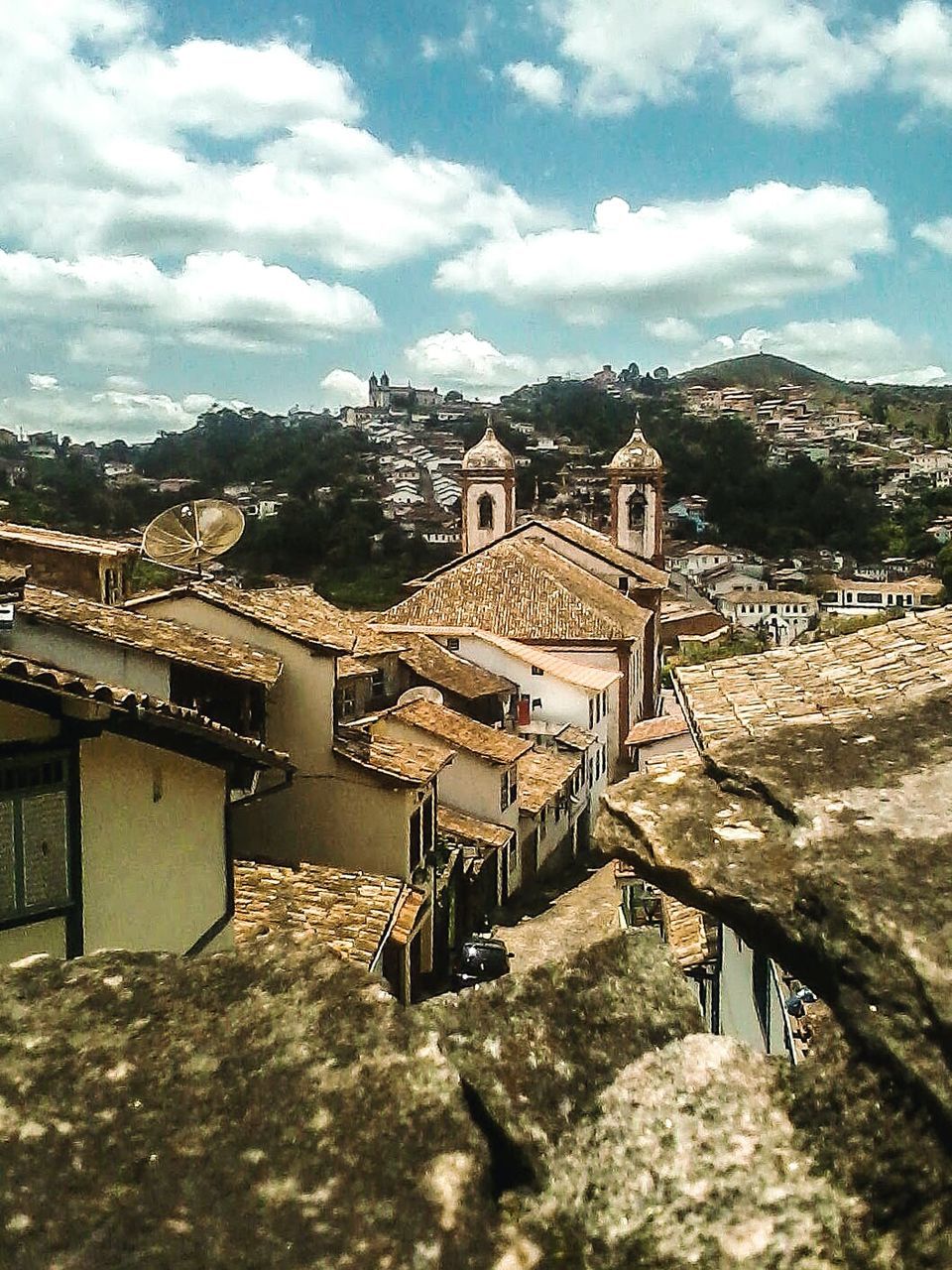 architecture, built structure, building exterior, sky, place of worship, history, cloud - sky, religion, spirituality, roof, town, mountain, travel destinations, cloud, house, tourism, famous place, church, the past