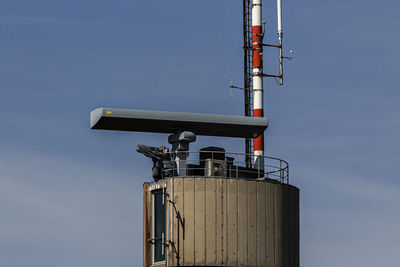 Low angle view of communications tower against sky