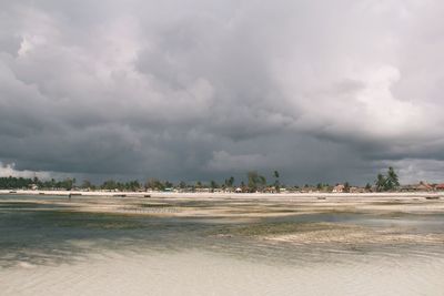 View of beach against cloudy sky