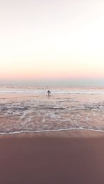 Scenic view of sea against clear sky during sunset