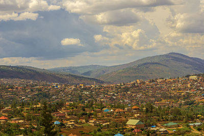 Town by mountains against sky