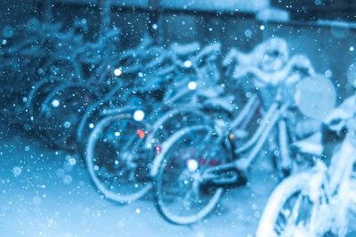 Bicycles parked on footpath during snow fall