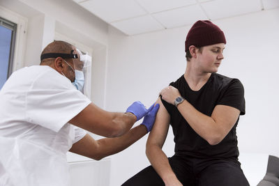 Young man getting vaccinated against covid-19