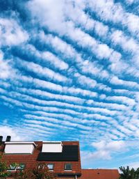 Low angle view of buildings against cloudy sky