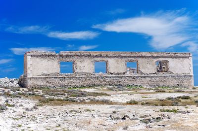 Low angle view of historical building against blue sky