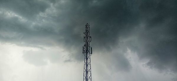 Low angle view of communications tower against sky