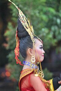 Side view of young woman wearing headdress during festival