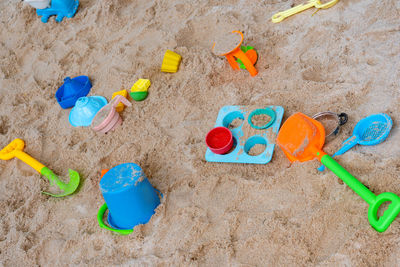 High angle view of multi colored toy on sand