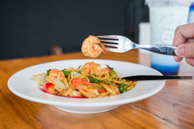 Close-up of person holding food on table