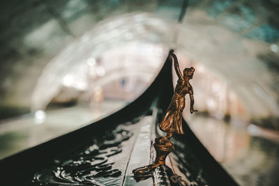 Close-up of statue on boat in canal