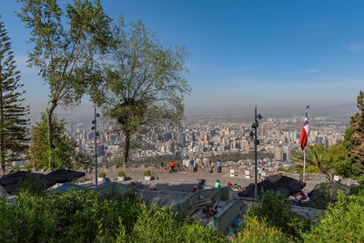 High angle view of trees and buildings in city against sky