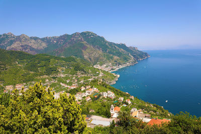 Scenic view of sea and buildings in town