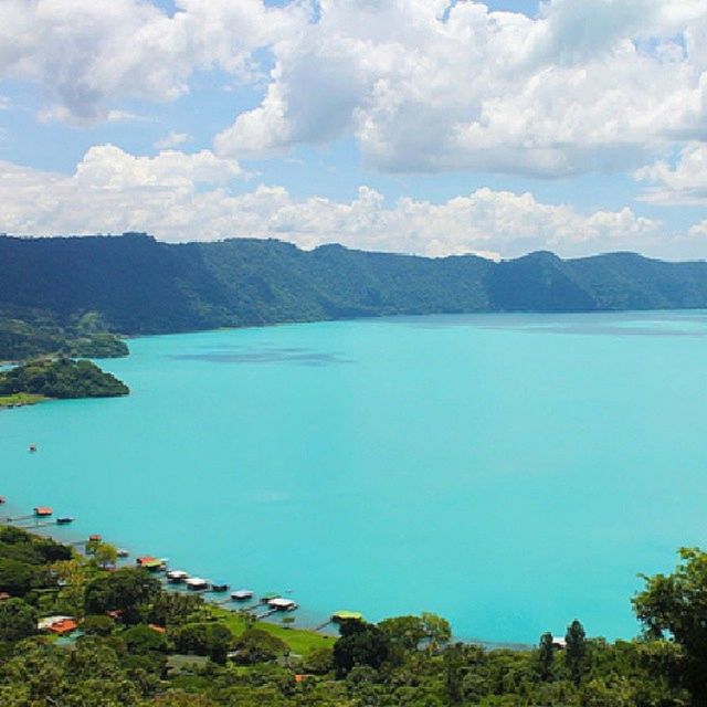 mountain, water, scenics, mountain range, tranquil scene, sky, tranquility, beauty in nature, sea, high angle view, nature, blue, lake, cloud - sky, tree, idyllic, landscape, cloud, outdoors, day