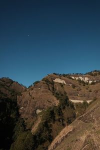 Scenic view of landscape against clear blue sky at night