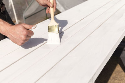 Midsection of man working on table