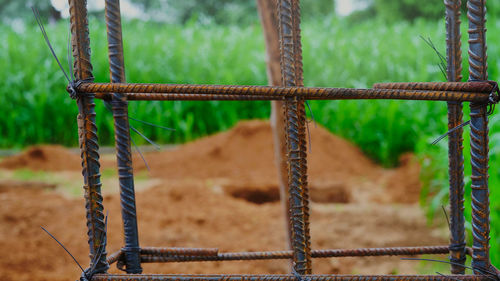Close-up of barbed wire fence on field