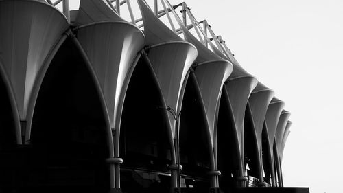 Low angle view of industry against clear sky