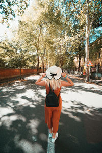 Rear view of woman standing on street