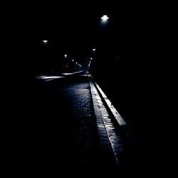 Illuminated tunnel at night