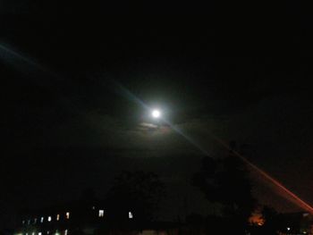 Illuminated lights against sky at night