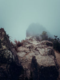 Low angle view of rock formation against clear sky