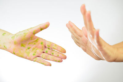 Close-up of hands over white background