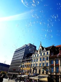 Low angle view of buildings against blue sky