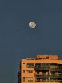 Low angle view of airplane flying against clear sky