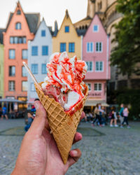 Cropped hand holding ice cream cone