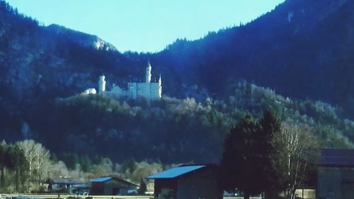 Panoramic view of trees and mountains against sky