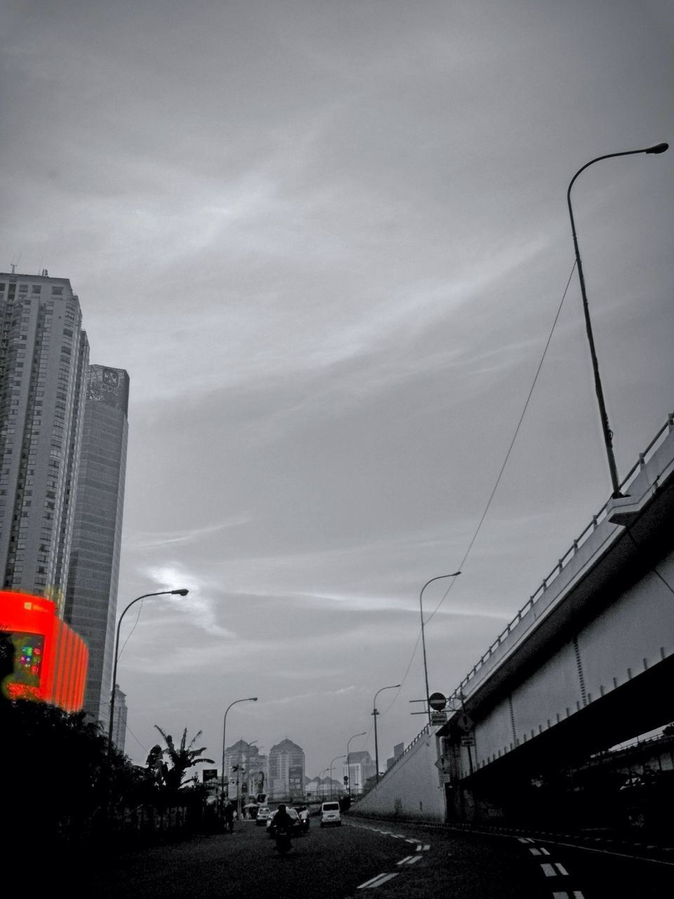 transportation, building exterior, sky, architecture, built structure, mode of transport, city, car, cloud - sky, land vehicle, street light, low angle view, street, cloudy, road, outdoors, cloud, connection, city life, building