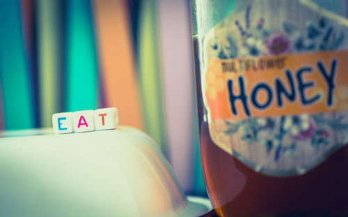 Close-up of text on glass table