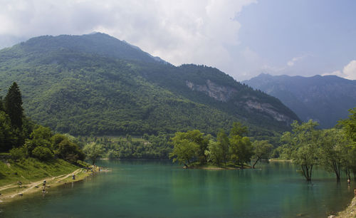 Scenic view of lake and mountains against sky