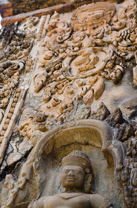 Buddha statue against stone wall