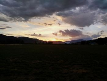 Scenic view of field against sky during sunset