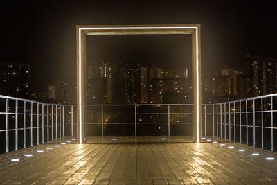 Illuminated modern building against sky at night