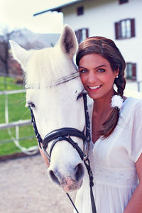 Portrait of young woman with horse