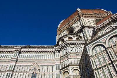 Low angle view of building against clear blue sky