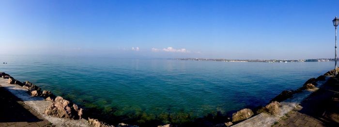 Panoramic view of sea against blue sky