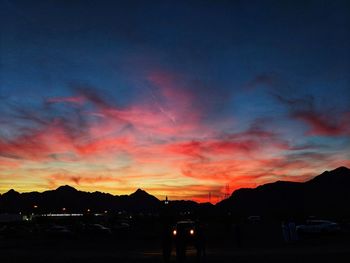 Silhouette buildings against sky during sunset